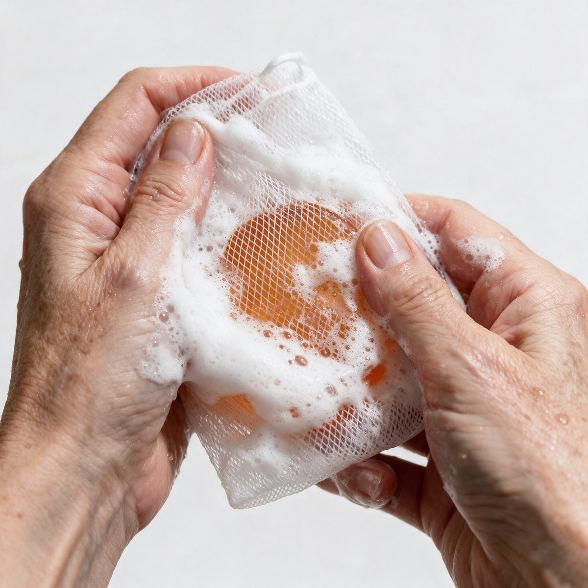 Working the Gosho bar into foam inside its mesh lather bag