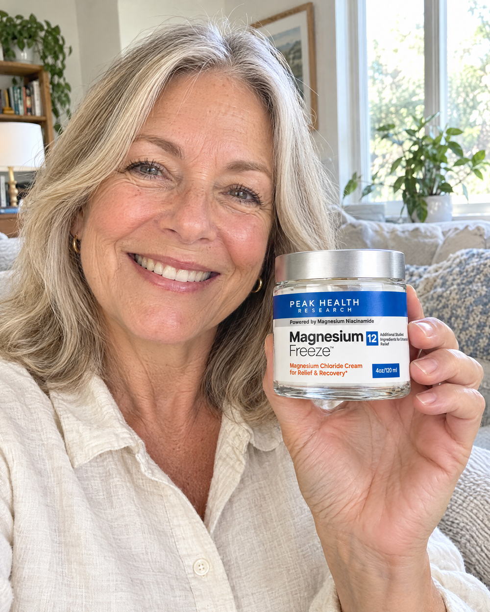 Smiling woman holding a jar of Magnesium Freeze